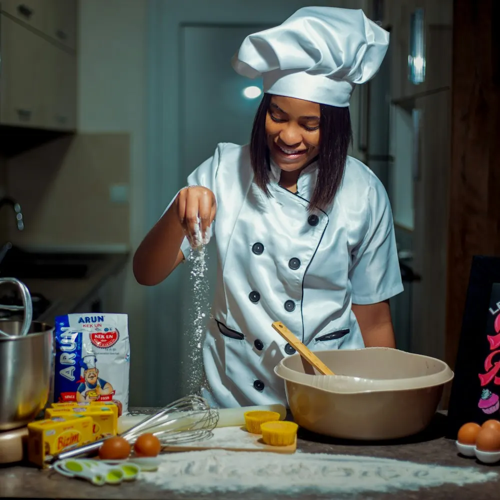 Baker in chef whites preparing a cake mix in the kitchen